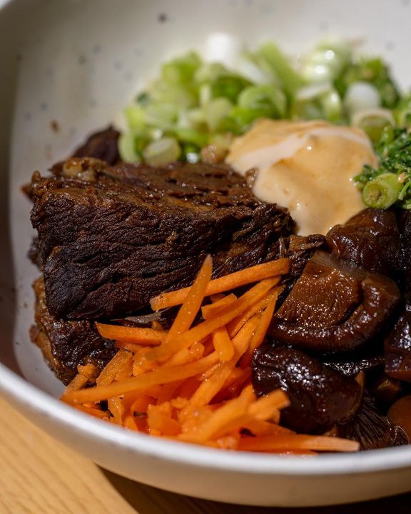 braised beef rice bowl with pickled carrot, mushrooms, scallion and spicy mayo